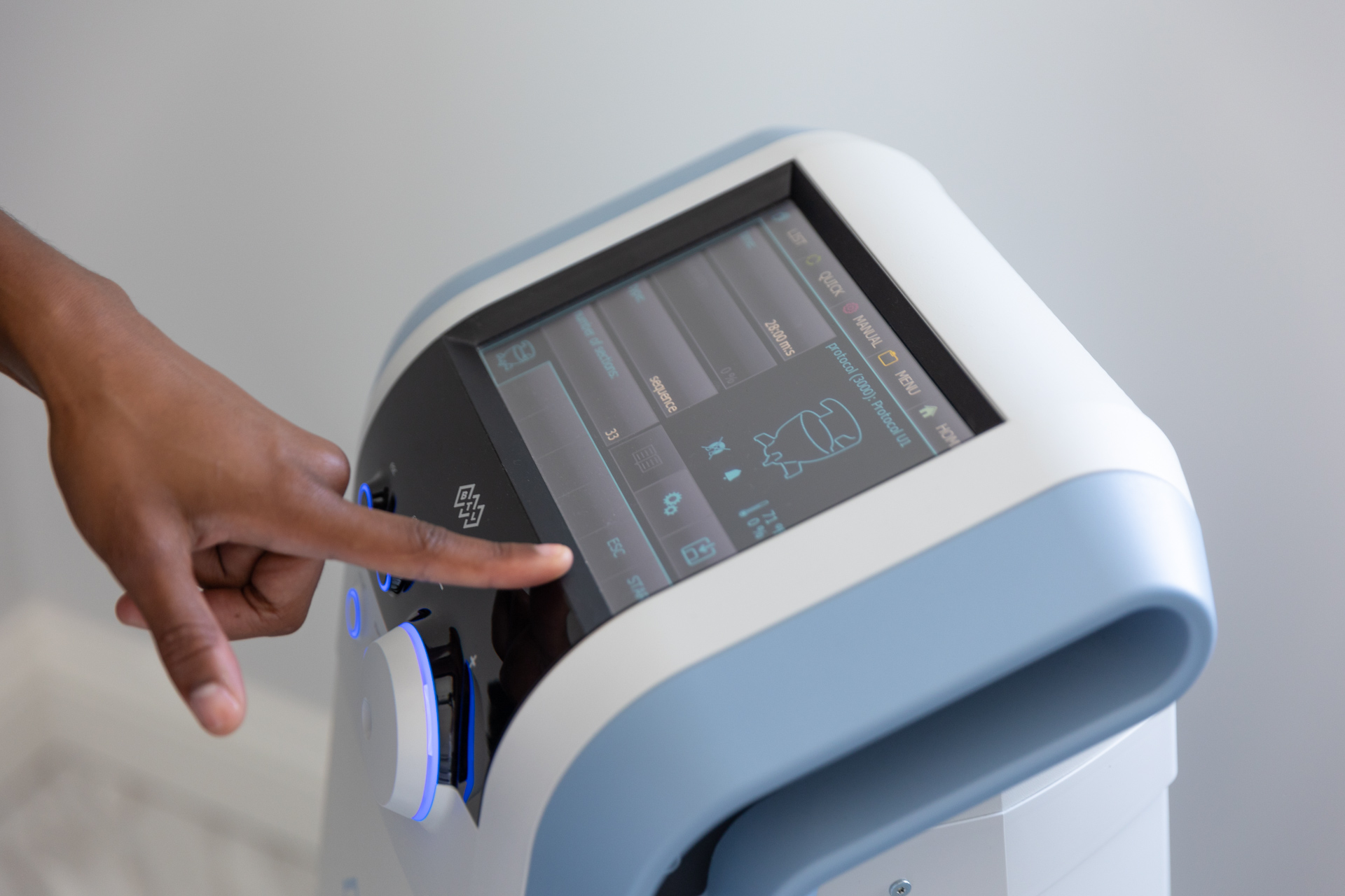 A provider adjusts the settings on the workstation of Emsella near Sarasota.