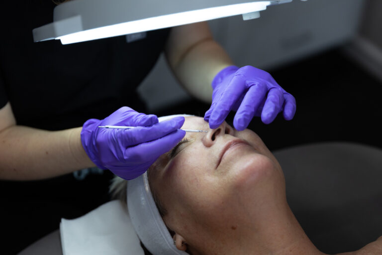 A provider wearing purple gloves doing an extra as part of their Facials in Englewood, FL